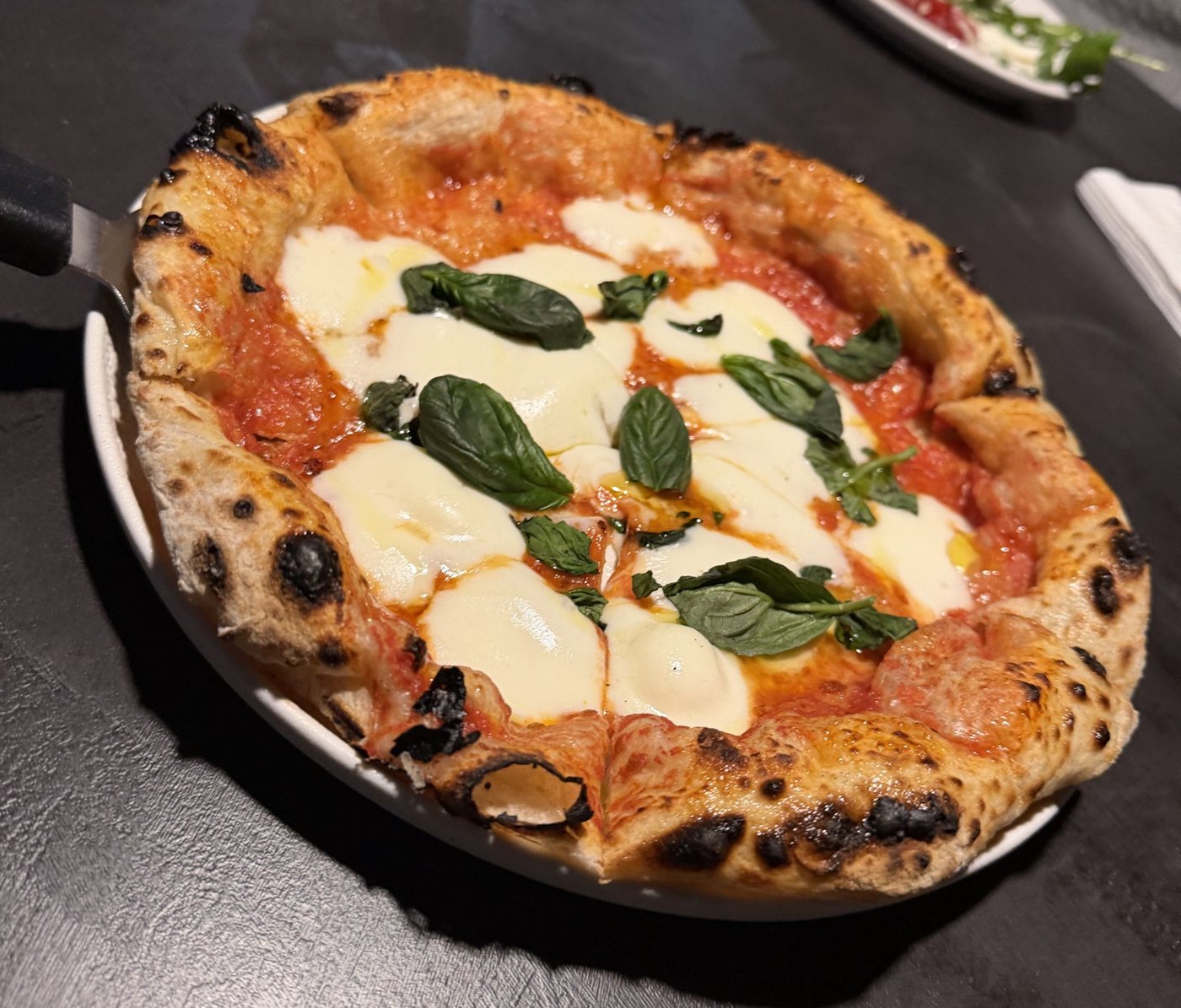 Margherita pizza, puffed edges with a few charred spots